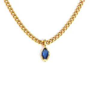 Macro view of gold stainless steel chain necklace with marquise blue zircon pendant