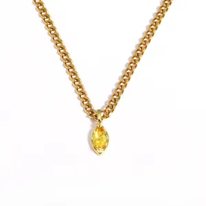 Close-up of gold stainless steel necklace with marquise yellow zircon pendant
