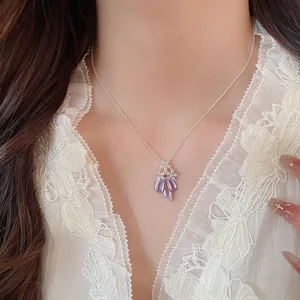 Detailed shot of the elegant purple enamel butterfly pendant with sparkling zircons
