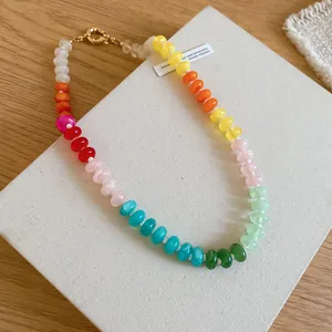 Detail of colorful rainbow acrylic beaded necklace in vibrant dopamine style.