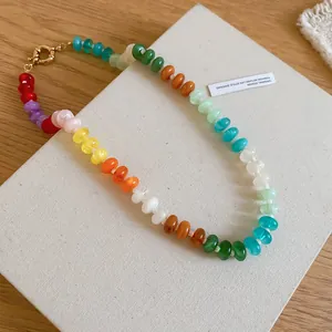 Close-up view of a vibrant rainbow acrylic beaded necklace in a trendy dopamine style