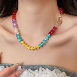 Close-up of a vibrant rainbow acrylic beaded necklace featuring a large gold-toned clasp