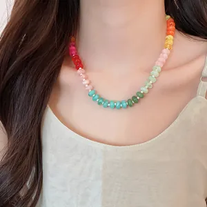Close-up view of a vibrant rainbow acrylic beaded necklace worn as a clavicle chain