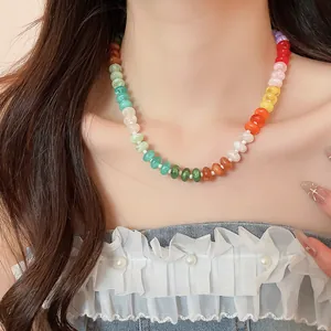 Detail of a colorful rainbow acrylic beaded choker necklace on a female model.