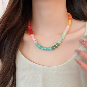 Close-up of rainbow acrylic beaded necklace worn on neck for a sweet dopamine style