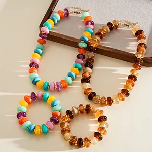 Macro view of colorful acrylic beaded necklaces and bracelets under warm sunlight