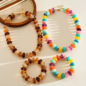Detailed view of colorful marbled acrylic beaded necklaces and matching bracelets.