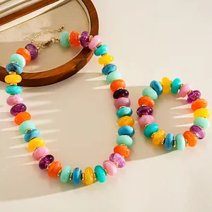 Detailed close-up shot of colorful marbled acrylic bead necklace and matching bracelet set