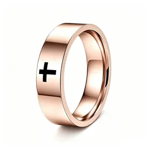 Close-up of rose gold stainless steel ring featuring a minimalist black cross design