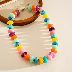 Detail of colorful marbled acrylic bead necklace with retro aesthetic and vibrant hues.