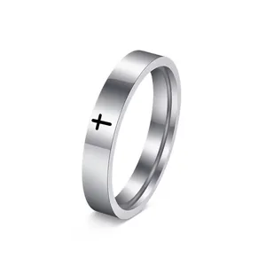 Detailed view of a minimalist stainless steel ring with a black cross engraving.