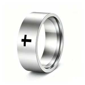 Detail of a punk style stainless steel ring featuring a black cross design on silver band