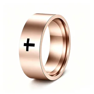 Detailed view of a rose gold stainless steel ring featuring a black engraved cross motif