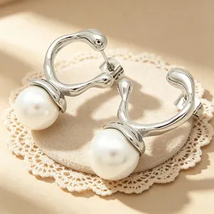 Close-up of minimalist stainless steel irregular earrings with large white pearls