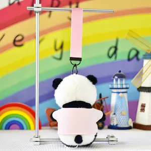 Cute panda plush keychain wearing a pink t-shirt, back view with wrist strap hanging.