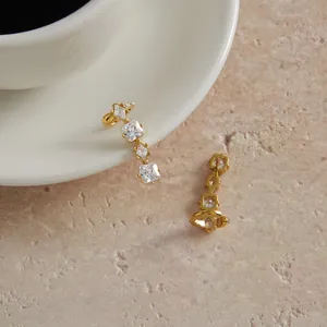 Detailed view of titanium steel ear cuffs featuring sparkling clear square cubic zirconias.