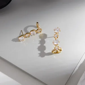 Detailed view of elegant gold stainless steel stud cuff earrings with cubic zirconia