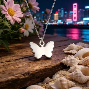 Close-up of a polished butterfly pendant necklace on a rustic wood and seashell background
