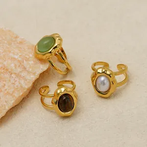 Close-up of three 14K gold plated stainless steel open rings with natural stones and pearls