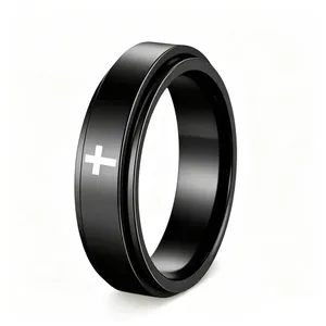 Detailed macro view of a black rotatable stainless steel spinner ring with a white cross