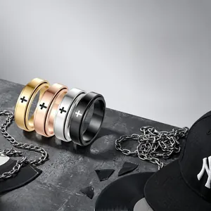 Close-up of four rotating stainless steel rings with cross patterns in various finishes