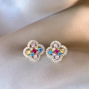 Detailed view of elegant multi-color floral stud earrings featuring sparkling crystals on satin