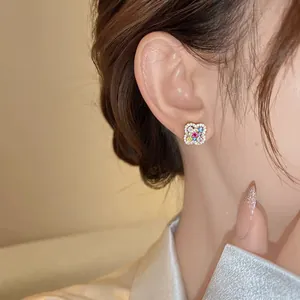 Detailed close-up view of a floral clover stud earring with colorful gems and diamonds