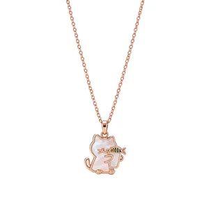 Rose gold kitten necklace with white shell pendant and small fish charm on white background.