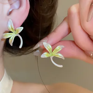 Close-up of elegant orchid flower earrings with pearly white and lime green petals