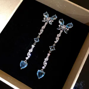 Elegant long blue butterfly and heart zircon dangle earrings displayed in a luxury box