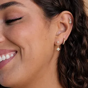 Close-up of 18k gold stainless steel earring set with sparkling zircon studs and hoops
