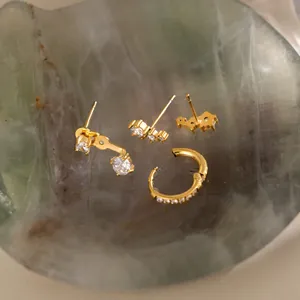 Detailed view of 18k gold plated stainless steel earrings set with zircon stones.