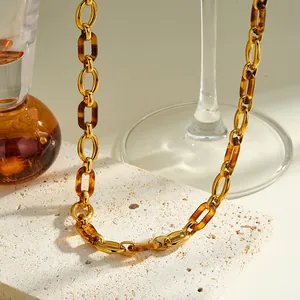 Detailed macro shot of vintage amber resin and gold stainless steel link necklace