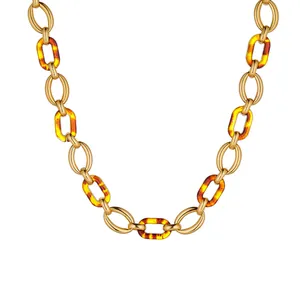 Macro detail of amber resin and gold stainless steel links on a vintage chain necklace