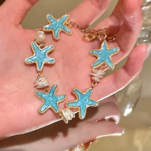 Close-up of mint blue starfish bracelet with white pearls for beach vacation style