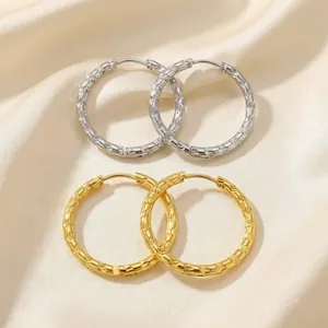 Embossed 18K gold plated and silver stainless steel hoop earrings in a minimalist style