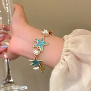 Elegant mint starfish bracelet with pearls worn on wrist, perfect for vacation style