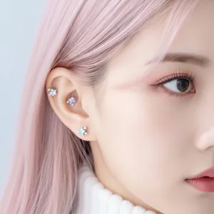 Elegant titanium star cartilage ear studs with colorful zircon stones on model