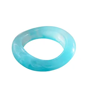 Chunky light blue resin marbled bangle with unique elliptical concave geometric design