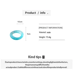 Detail view of a light blue marbled resin oval bangle with size and material info.