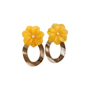 Sweet Bohemian style yellow resin flower earrings with textured gold oval metal hoops.