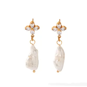 Detailed view of gold stainless steel earrings with CZ flower and baroque pearl.