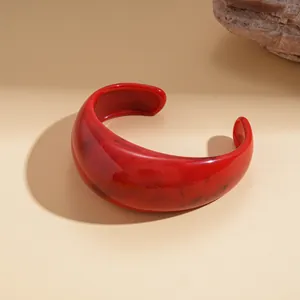 Elegant red marbled resin cuff bracelet featuring a minimalist geometric design