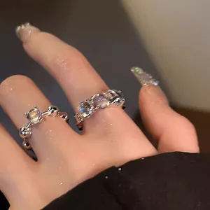 Detailed macro view of Korean style sparkling zircon open rings worn on index finger
