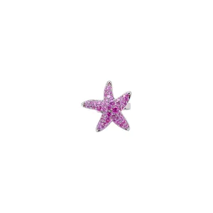 Dainty silver starfish ear cuff with pink cubic zirconia stones on white background