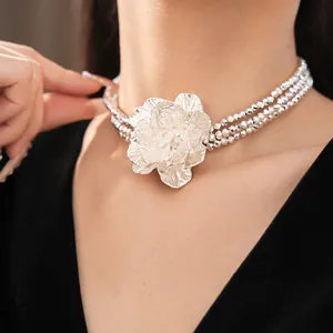 Close-up of elegant silver multi-layer beaded choker with exquisite floral pendant