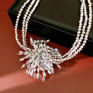Close-up of luxury multi-layer silver beaded necklace with crystal flower pendant