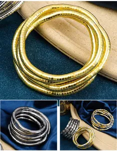 Flexible snake-shaped jewelry styled as bracelets and necklaces in gold and silver finish