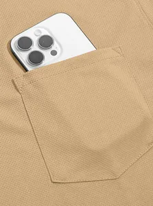 Detailed view of tactical polo shirt pocket in durable khaki bird-eye fabric texture.