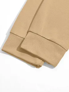 Close-up of khaki birdseye fabric cuffs on men's tactical long-sleeved polo shirt